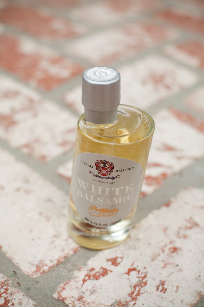 A bottle of White Balsamic Vinegar to be used in Shaved Brussels Sprouts and Date Salad