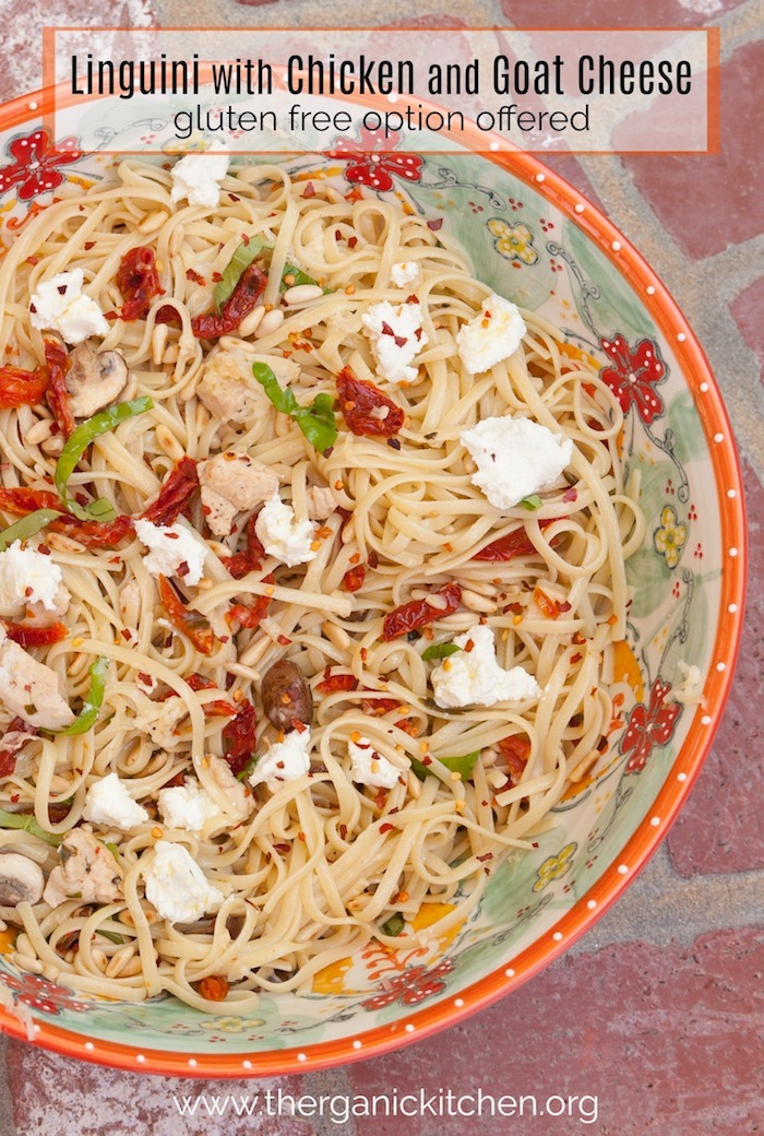 Linguini with Chicken and Goat Cheese in a colorful bowl set on a brick surface