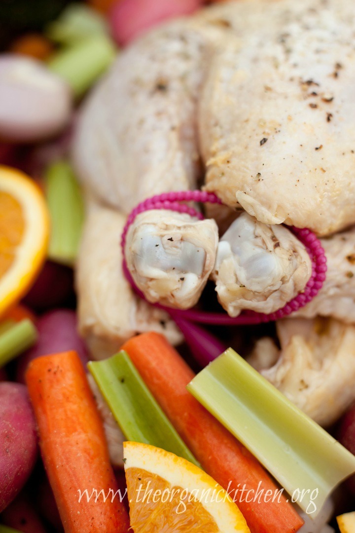 A close up of raw chicken with legs tied. Roasted Apricot Chicken from The Organic Kitchen