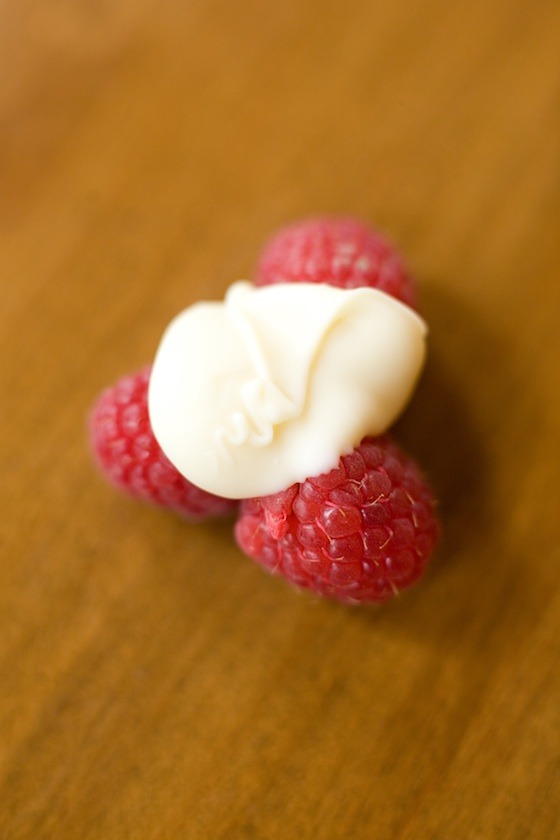 One White Chocolate Raspberry Cluster on wood table