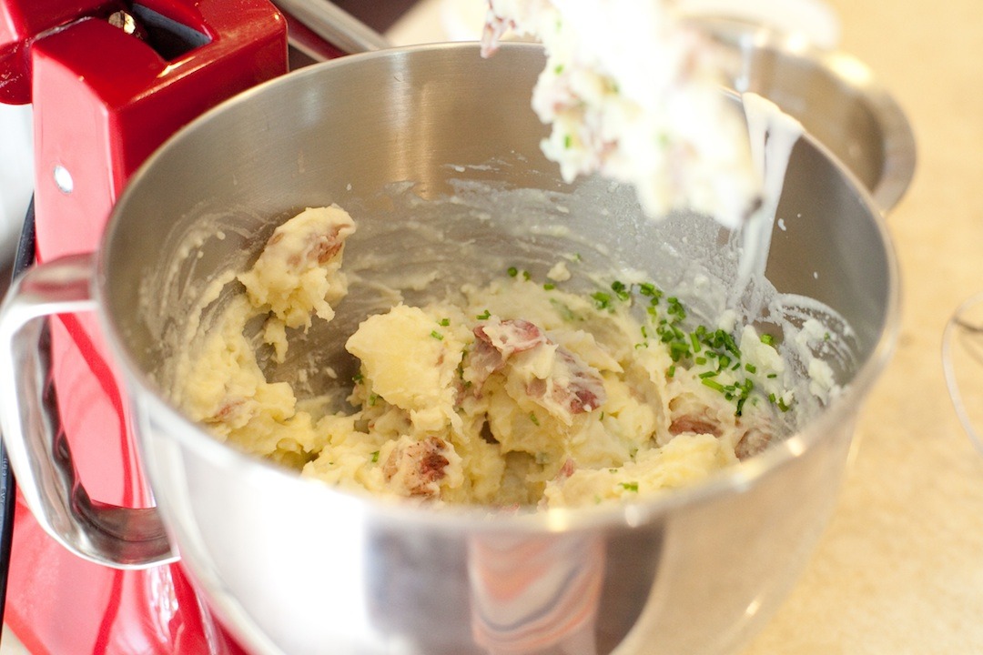 A mixing bowl filled with Decadent Smashed Potatoes 