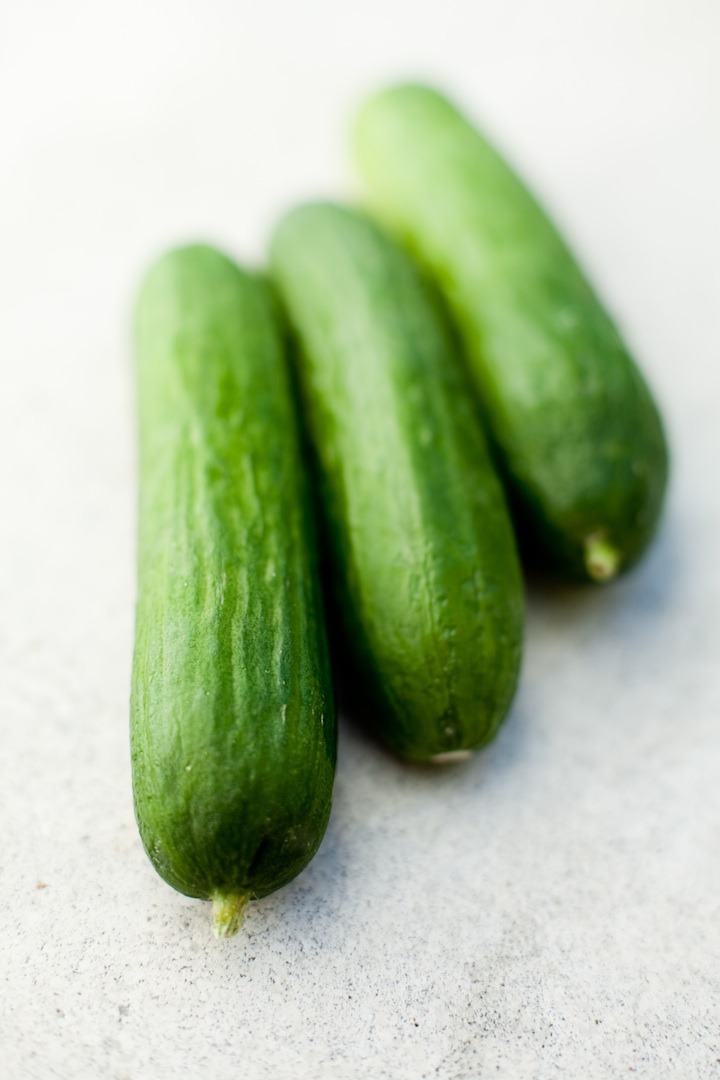 Three Persian Cucumbers on marble surface