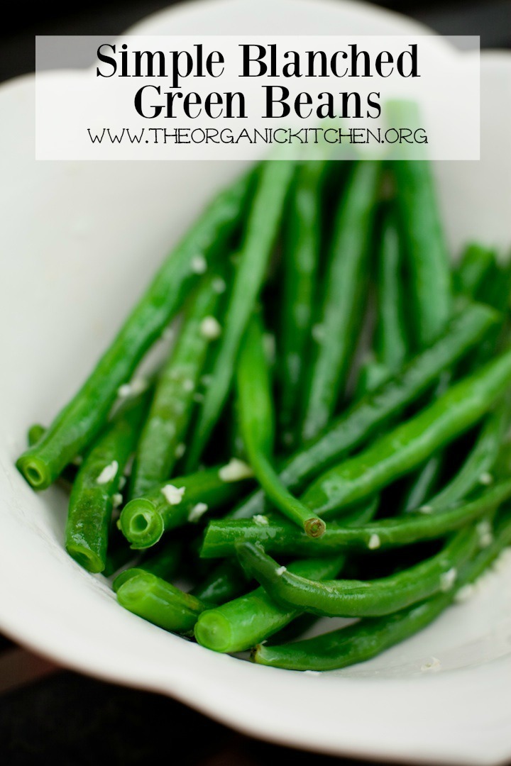 Bright green Simple Blanched Green Beans in a white bowl on black background