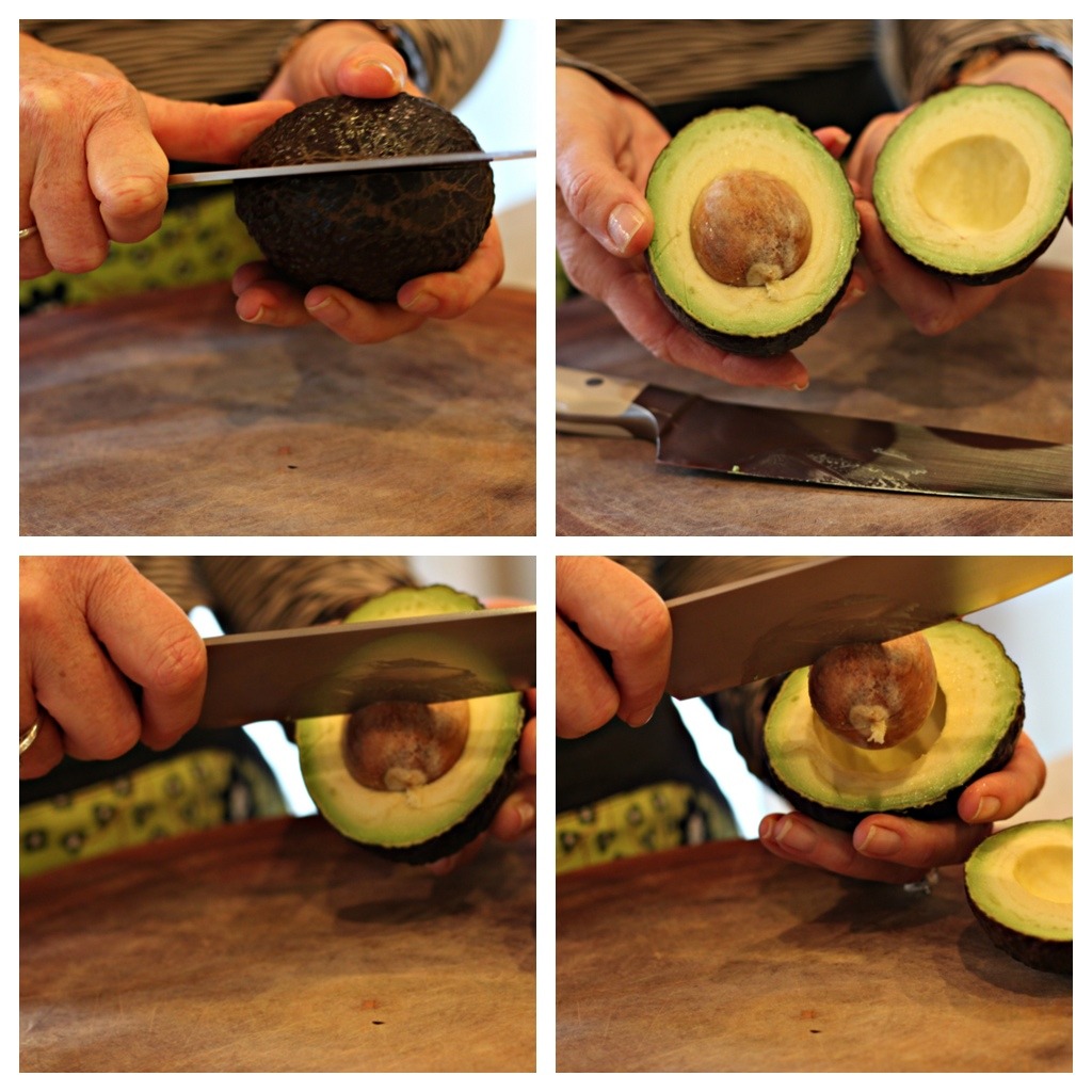 How to slice an avocado: a woman's hands holding a knife and demonstrating how to score an avocado and remove the seed 