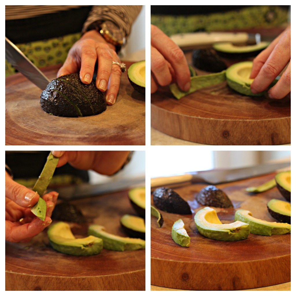 How to slice an avocado: a woman's hand with knife demonstrating how to slice and peel and avocado