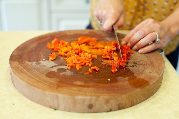 How to Roast a Red Bell Pepper: a woman's hands dicing roasted red bell pepper