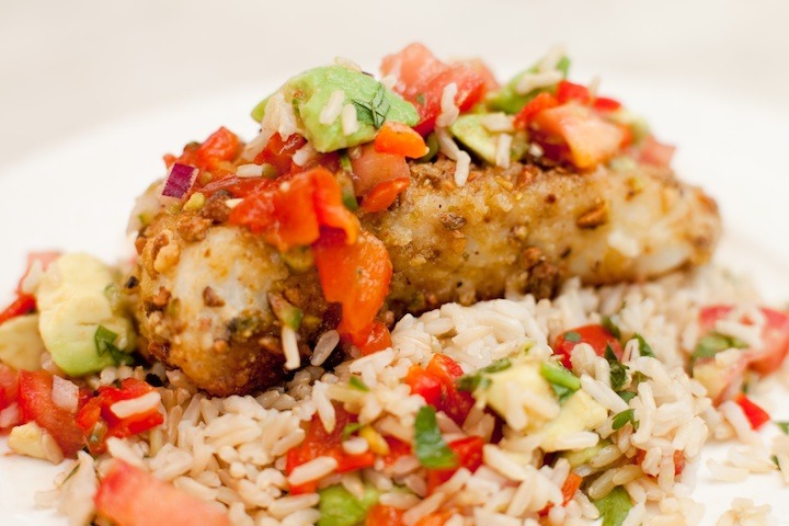 How to Roast a Red Bell Pepper: a white plate filled with rice and halibut smothered in red bell pepper salsa