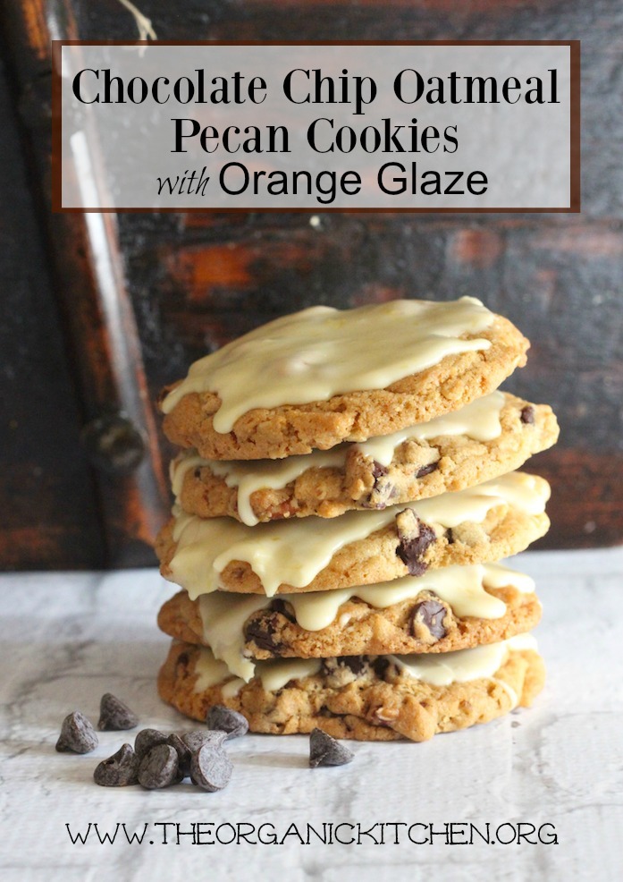 A stack of Chocolate Chip Oatmeal Pecan Cookies with Orange Zest Glaze on white brick surface in in front of an aged wood wall