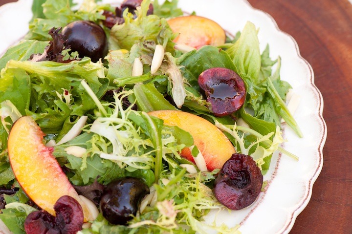 Greens with Nectarines and Cherries on white plate 