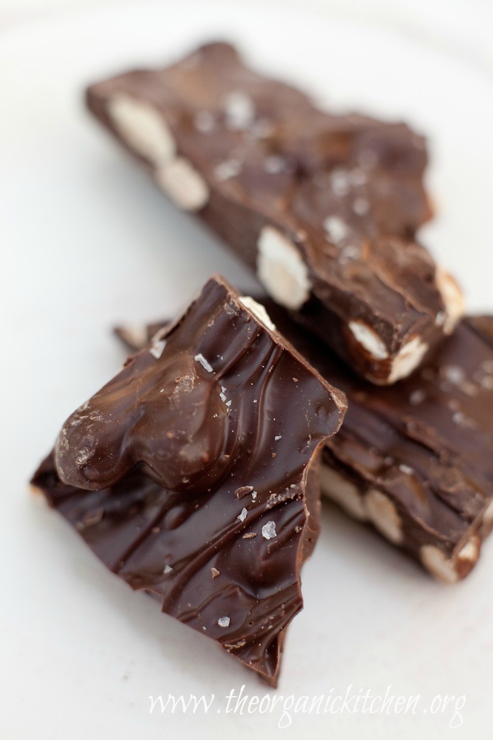 How to Make Chocolate Bark: Three pieces of chocolate bark with almonds and sprinkled with sea salt