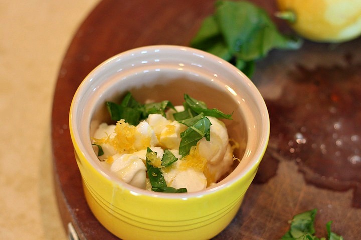 A yellow bowl with mozzarella, basil, and lemon zest used to make Easy Mozzarella Lemon Basil Crostini