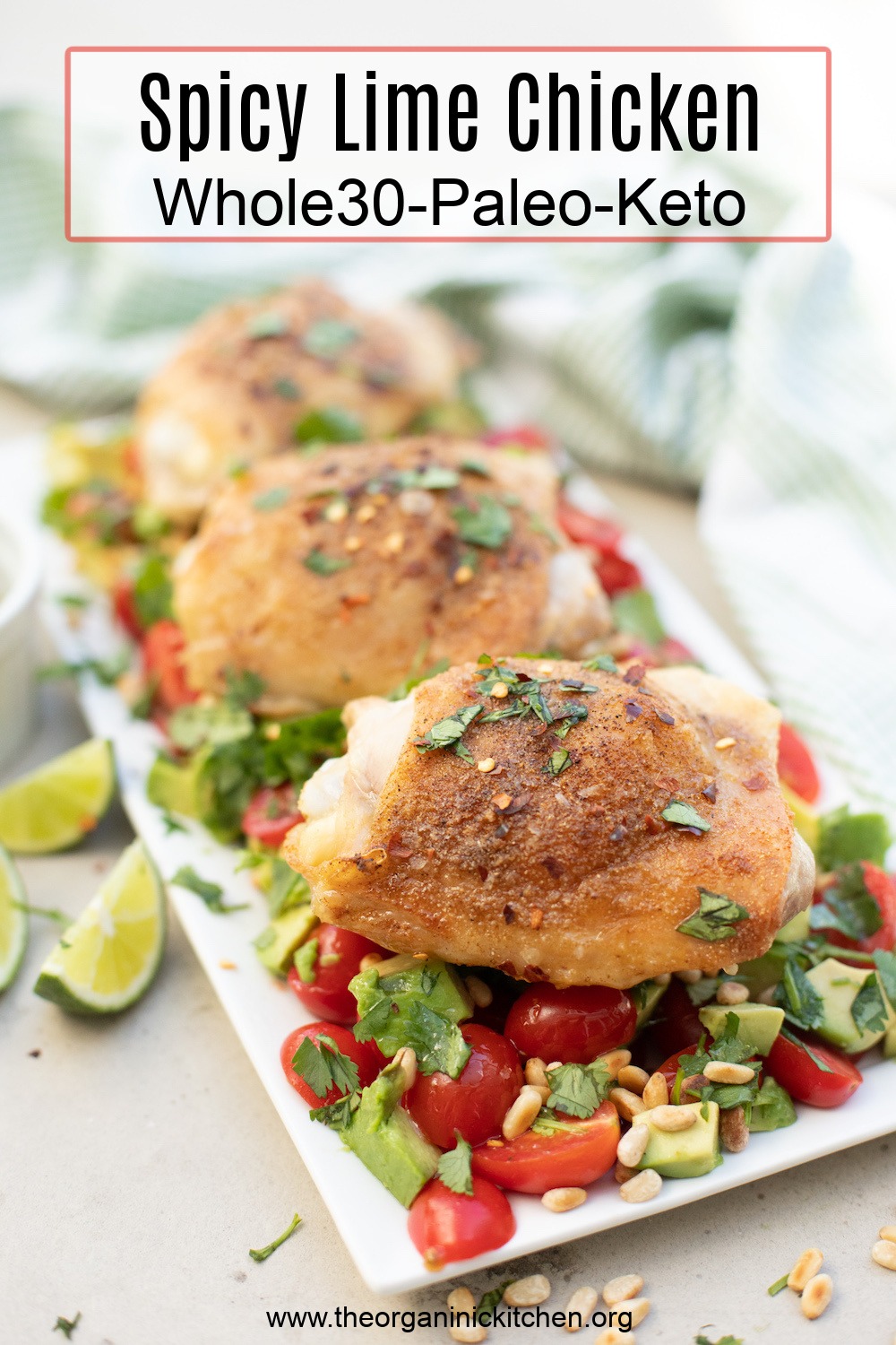 Spicy Lime Chicken garnished with cilantro on top of a bed of tomatoes and avocado on white plate