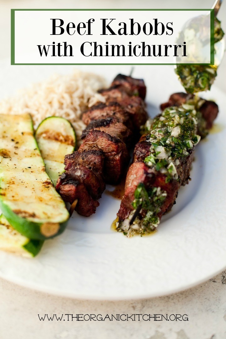Argentinian Beef Kabobs with Chimichurri Sauce on white plate with grilled zucchini 