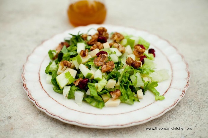 The Chopped Salad with Apple Vinaigrette on a white plate set on a marble table