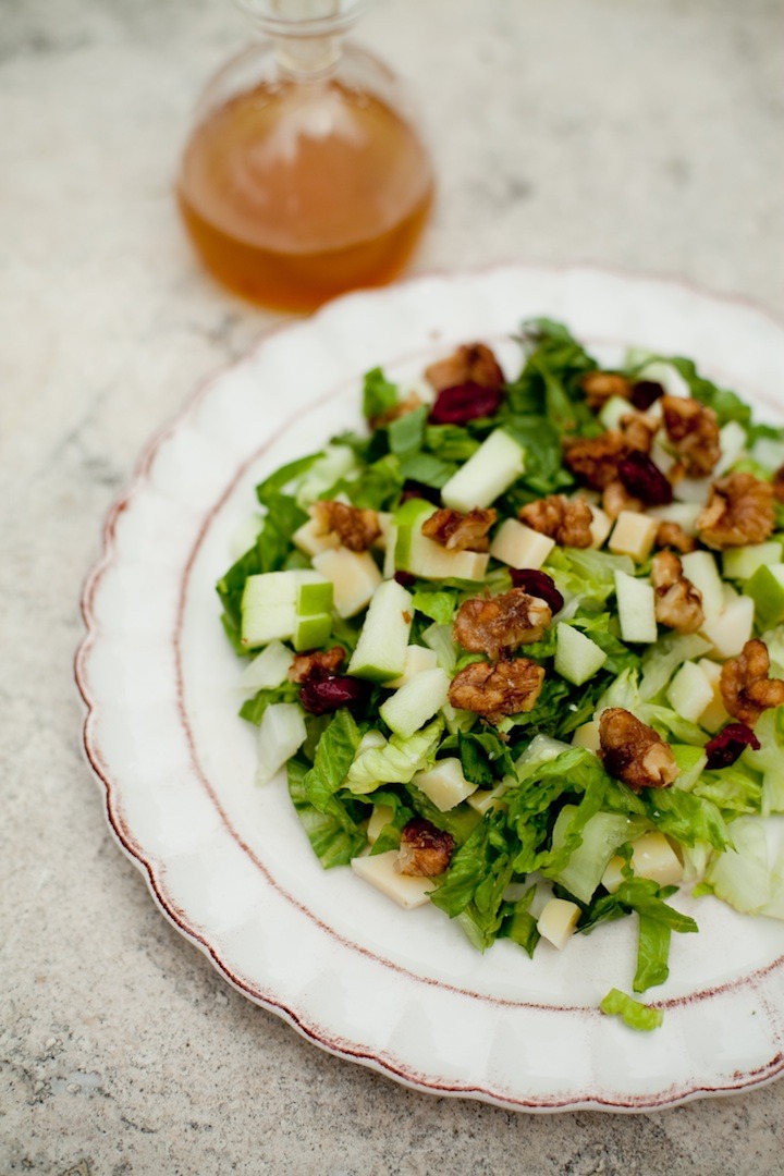 Chopped Salad with Apple Vinaigrette from The Organic Kitchen on a white plate set on a marble surface