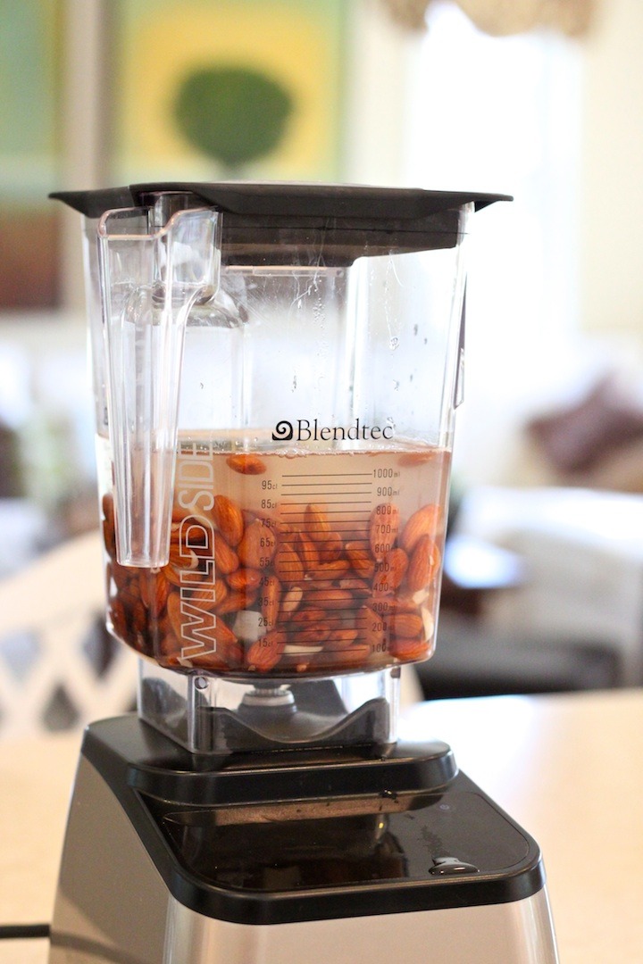 A blender with water and soaked almonds. How to Make Almond Milk