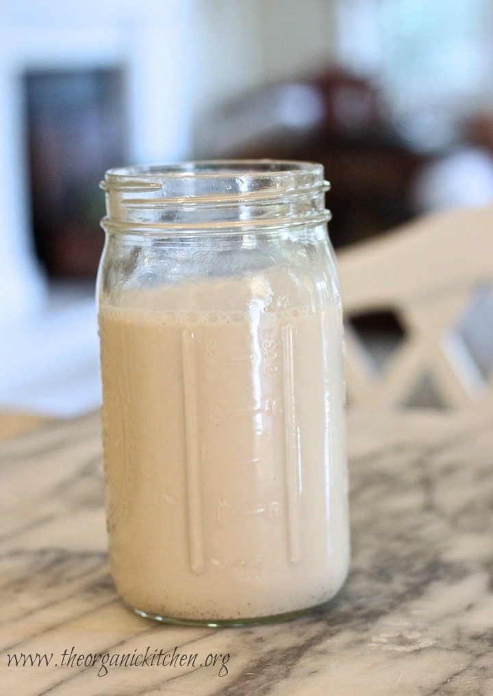A jar of homemade vanilla almond milk on marble counter: Dairy Free "Creamy Dreamy Strawberry Breakfast Smoothie"