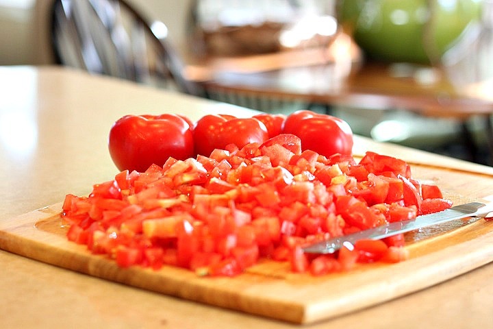 Fresh tomatoes diced on a cutting board: Creamy Carrot Tomato Soup: Comfort Food at it's Finest