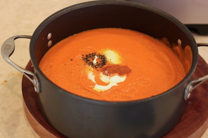 A big black pot filled with Creamy Carrot Tomato Soup: Comfort Food at it's Finest!