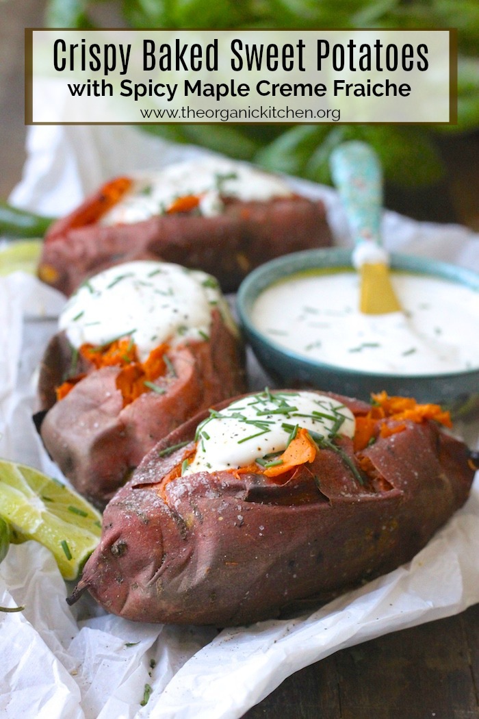 Baked Sweet Potatoes with Spicy Maple Creme Fraiche on a white parchment paper with a bowl of dip