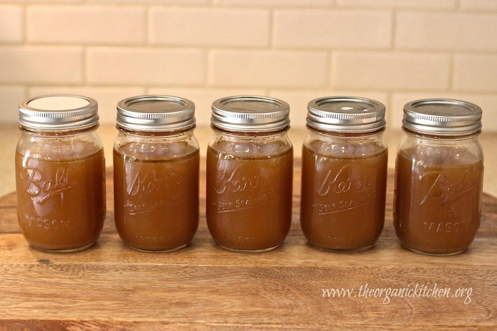 Five mason jars with lids filled with bone broth