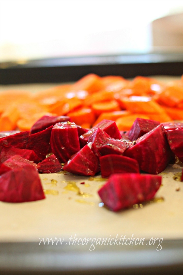 Beets and carrots glistening with olive oil on baking sheet ready to be roasted. Roasted Beet and Carrot Salad with Lemon White Balsamic Vinaigrette