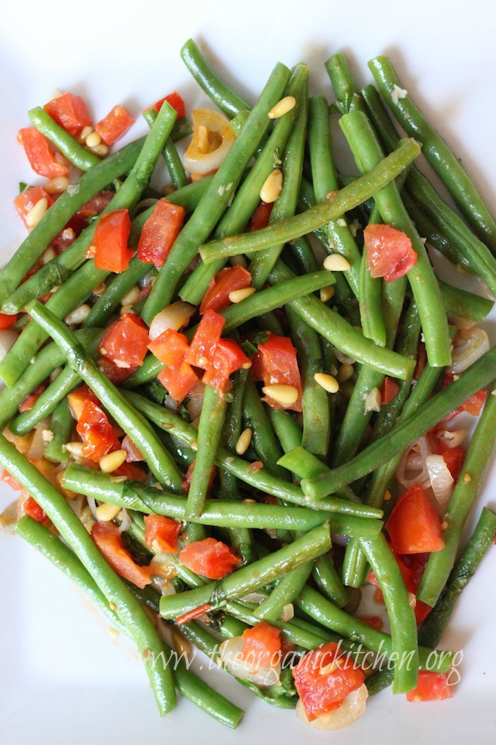 Green beans with diced tomatoes, pine nuts and chopped basil on white platter: Grandma Julia's Green beans