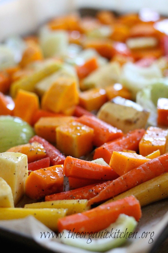 Vegetable drizzled with olive oil on a cookie sheet in preparation for making Roasted Vegetable Soup!