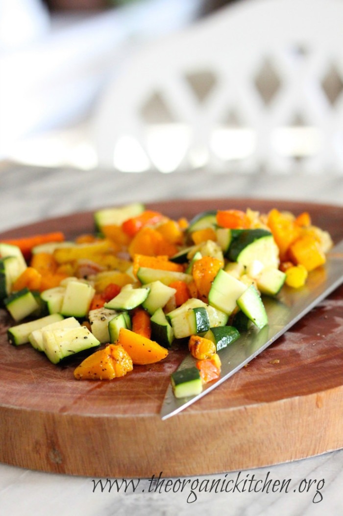 Roasted vegetables being chopped for Roasted Vegetable Soup!