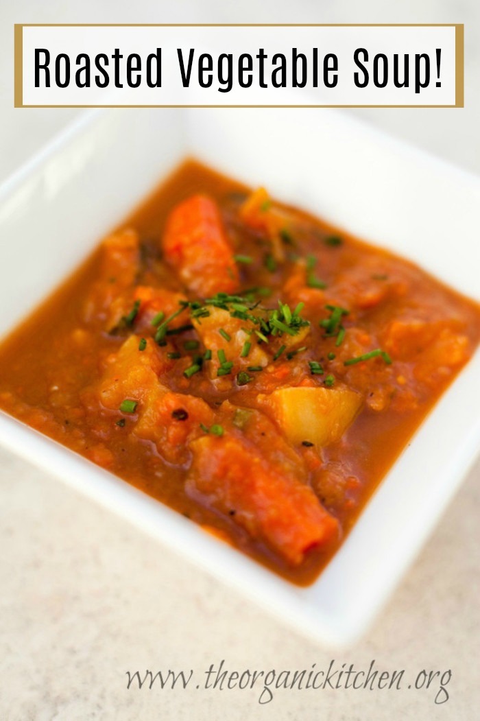 Roasted Vegetable Soup garnished with chives in white bowl 