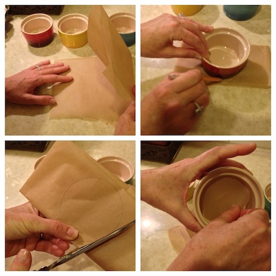 A female's hands demonstrating how to line ramekins with parchment paper