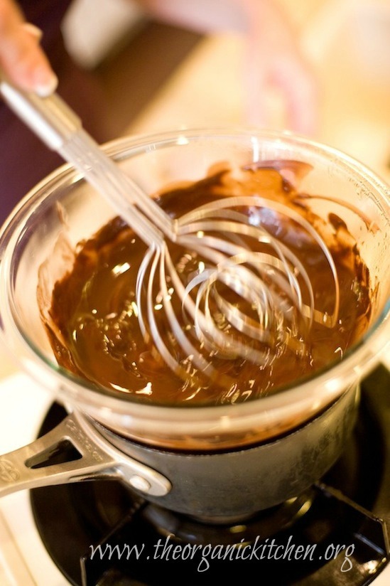 Melted chocolate being whisked in double boiler, used to make Molten Spiced Chocolate Pomegranate Cakes