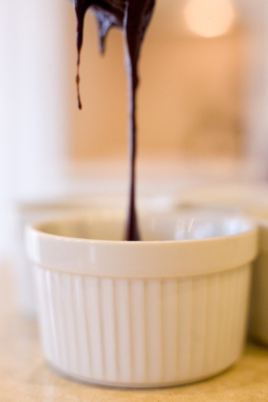 Batter for Molten Spiced Chocolate Pomegranate Cakes being poured into ramekin