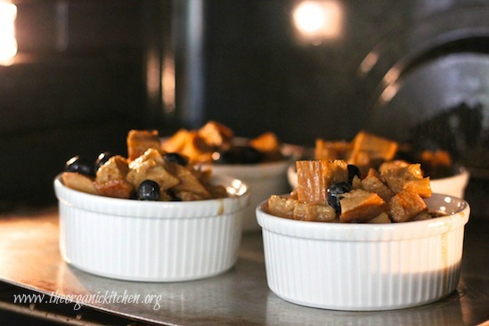 Four ramekins of Heavenly Blueberry Bread Pudding baking in the oven