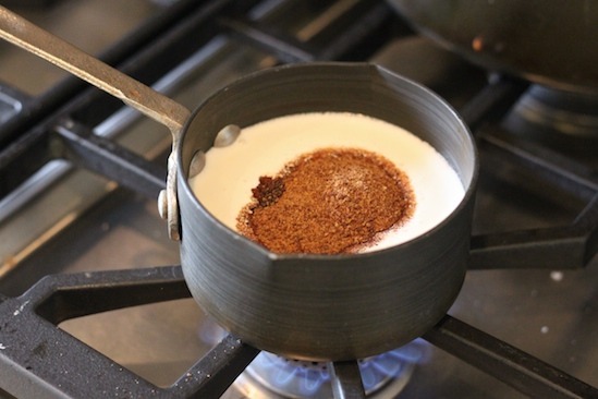 A pot of cream with coconut sugar on cooktop