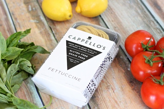 Basil, tomatoes and pasta on wood table for use in Fettuccine with Tomatoes and Burrata Cheese! Grain free option too.