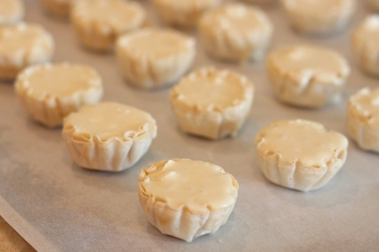 Mini Lemon Cheesecakes on cookie sheet before baking