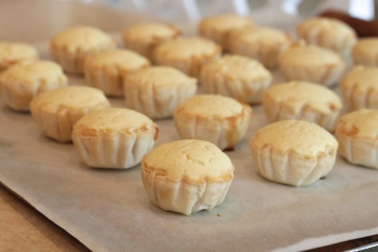 Mini Lemon Cheesecakes on baking sheet after baking