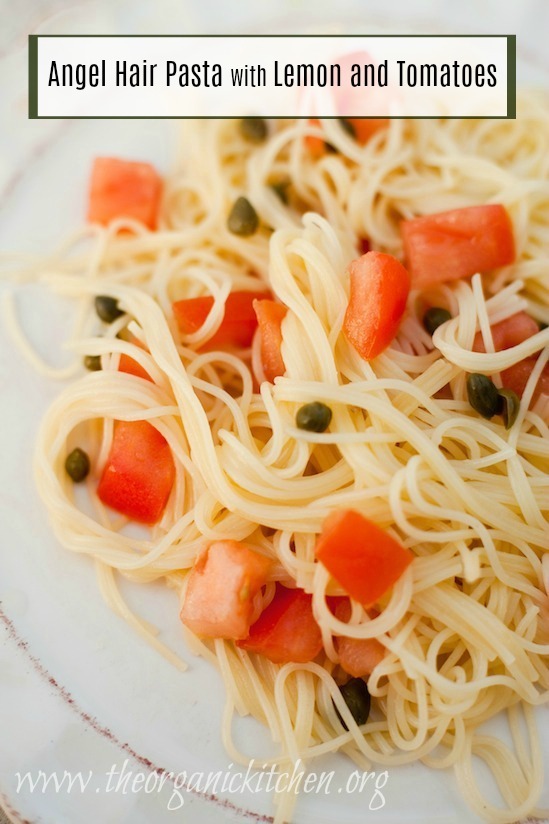 Angel Hair Pasta with Tomatoes and Lemon garnished with capers  on a white plate