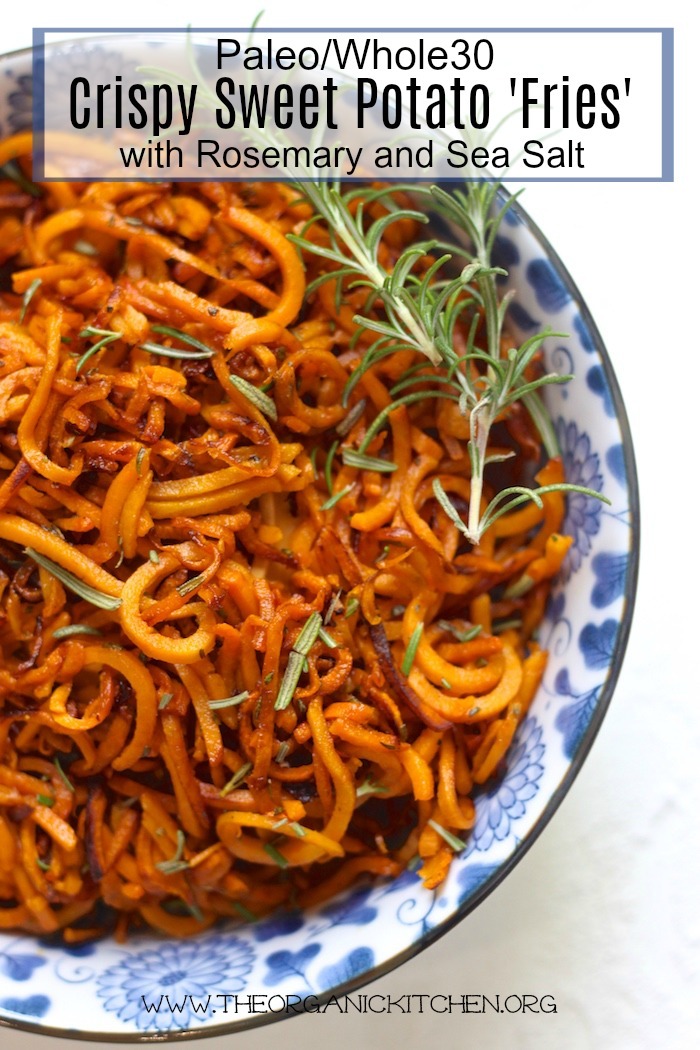 Crispy Sweet Potato 'Fries' with Rosemary and Sea Salt in a blue and white bowl on white backdrop