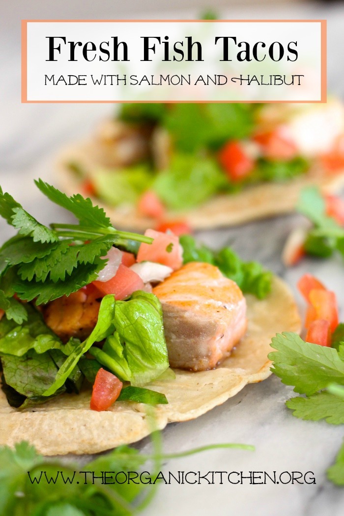 Fresh Fish Tacos garnished with lettuce, cilantro and pico de gallo on marble board