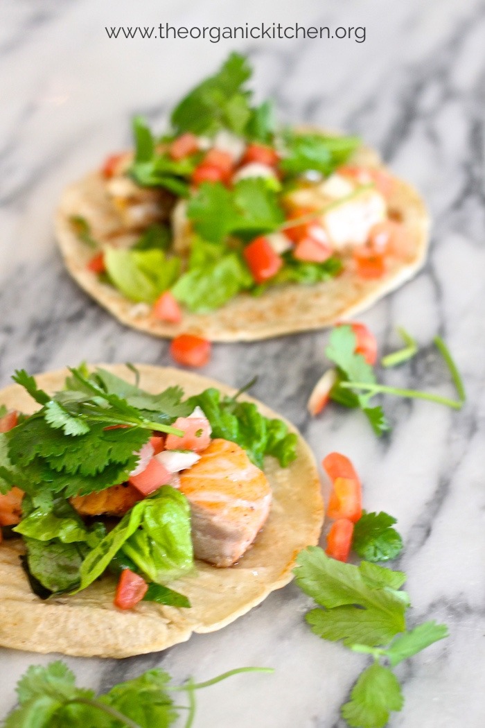 Two Fresh Fish Tacos with fixings on marble surface