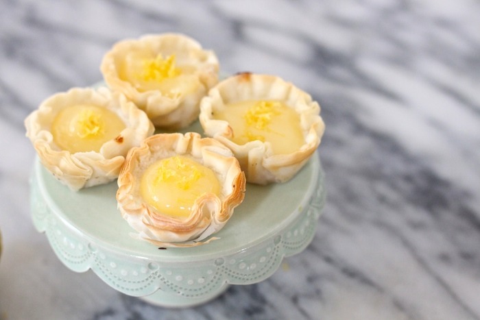 Four Mini Lemon Cheesecakes ona mint green cake stand