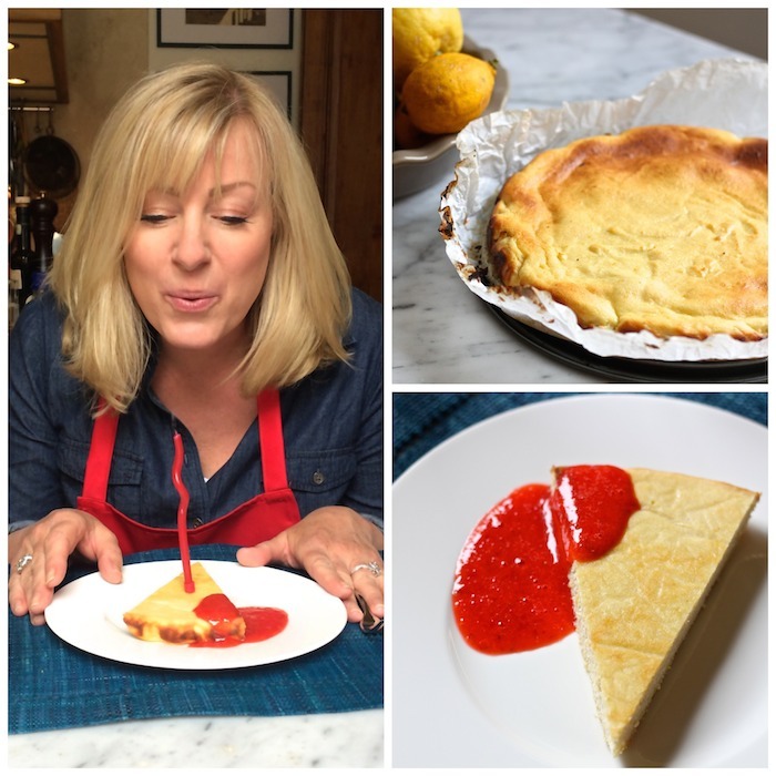 A blond woman blowing out a birthday candle on a triangular piece Lemon Ricotta Cheesecake