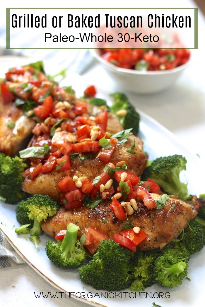 Grilled or Baked Tuscan Chicken over broccoli on a light blue plate
