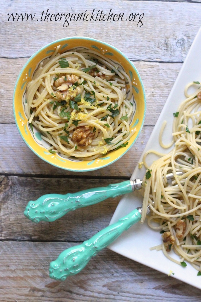 Simple Lemon Pasta with Walnuts in a yellow bowl and white platter