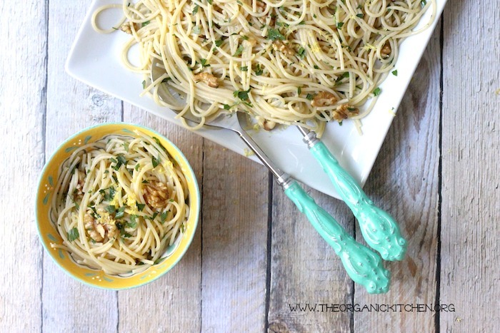 Simple Lemon Pasta with Walnuts served in a yellow bowl and on a white platter