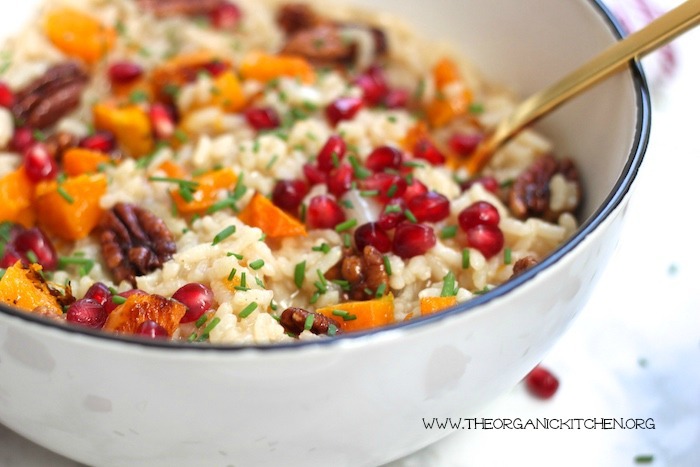 Roasted Butternut Squash Risotto with Candied Pecans in white bowl with gold spoon