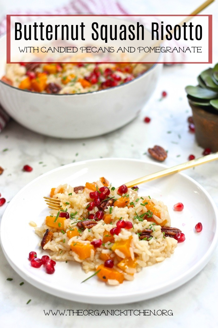 Roasted Butternut Squash Risotto with Candied Pecans garnished with pomegranate seeds on white plate with gold forks