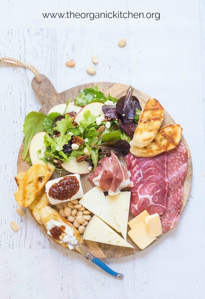 Salad and Charcuterie Board Dinner on white background with scattered almonds